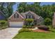 Charming brick home boasts a well-manicured lawn and inviting curb appeal at 1668 Macy Ln, Lawrenceville, GA 30043