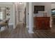 Hallway featuring wood-look floors, neutral walls, and view into multiple rooms of the home at 1668 Macy Ln, Lawrenceville, GA 30043