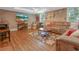 Cozy living room with hardwood floors, a comfortable sofa, and large TV at 1668 Macy Ln, Lawrenceville, GA 30043
