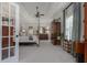 Spacious primary bedroom boasts tray ceilings, a ceiling fan, and a seating area at 1668 Macy Ln, Lawrenceville, GA 30043