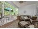 Inviting screened porch with comfortable wicker furniture and views of the wooded backyard at 1668 Macy Ln, Lawrenceville, GA 30043