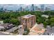 Aerial view of apartment building, trees and city skyline at 3235 Roswell Ne Rd # 702, Atlanta, GA 30305