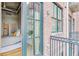 Balcony view of the bedroom featuring exposed brick and black iron railings at 3235 Roswell Ne Rd # 702, Atlanta, GA 30305