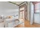 Cozy bedroom with exposed brick, natural light, and hardwood floors, offering a blend of comfort and style at 3235 Roswell Ne Rd # 702, Atlanta, GA 30305