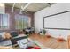 Living room with exposed brick wall, large windows, modern decor, and a comfortable sectional sofa at 3235 Roswell Ne Rd # 702, Atlanta, GA 30305