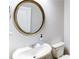 Clean bathroom with a white sink, toilet, and a stylish round mirror at 3410 Summerpoint Xing, Cumming, GA 30028