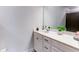 Well-lit bathroom with a large mirror, white cabinets, and a sleek marble countertop at 3410 Summerpoint Xing, Cumming, GA 30028