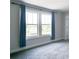 Bright bedroom featuring two large windows, plush carpeting, and stylish blue curtains at 3410 Summerpoint Xing, Cumming, GA 30028