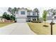 Charming two-story home with a spacious front yard and a large driveway leading to a two-car garage at 3410 Summerpoint Xing, Cumming, GA 30028