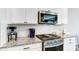 Close-up of a kitchen with modern appliances, granite countertops, and white subway tile backsplash at 3410 Summerpoint Xing, Cumming, GA 30028