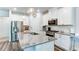 Stylish kitchen features white cabinets, stainless steel appliances, and a granite island at 3410 Summerpoint Xing, Cumming, GA 30028