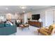 Bright living room with stylish furnishings, entertainment center, and neutral color palette at 3410 Summerpoint Xing, Cumming, GA 30028