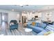 Open concept living area with modern furnishings, flowing seamlessly into the kitchen with an island at 3410 Summerpoint Xing, Cumming, GA 30028