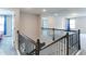 Staircase with dark brown railings and a view of the living area upstairs at 3410 Summerpoint Xing, Cumming, GA 30028