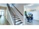 Elegant staircase with dark wood railing and black iron spindles, next to an open office space at 3410 Summerpoint Xing, Cumming, GA 30028