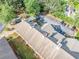 Aerial view showcasing an apartment complex with a neutral roof, parking area, and mature tree coverage around the building at 705 Beaufort Cir, Duluth, GA 30096
