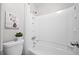 The bathroom features a white shower-tub combination, tile flooring, and white fixtures at 705 Beaufort Cir, Duluth, GA 30096