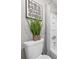A charming bathroom with tile shower, decorative art, and a decorative plant placed on the toilet at 705 Beaufort Cir, Duluth, GA 30096