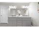 Bathroom with granite countertops, dual sinks, gray cabinets, large mirror and modern vanity lighting at 705 Beaufort Cir, Duluth, GA 30096