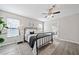 A charming bedroom boasts natural light, ceiling fan, gray walls, wood-look flooring, and modern furnishings at 705 Beaufort Cir, Duluth, GA 30096