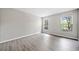 This spacious bedroom features two bright windows and modern gray wood-look flooring at 705 Beaufort Cir, Duluth, GA 30096
