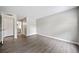 This is a spacious bedroom with gray wood-look floors, a closet, and an entry to the bathroom at 705 Beaufort Cir, Duluth, GA 30096