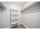 An empty walk-in closet with built-in shelves and gray wood flooring is ready for storage at 705 Beaufort Cir, Duluth, GA 30096