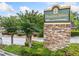 Stone Hampton Arbors community sign surrounded by landscaping and small trees, creating a welcoming entrance at 705 Beaufort Cir, Duluth, GA 30096
