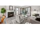 Cozy living room with a fireplace, modern furnishings, and neutral decor with access to a sunroom at 705 Beaufort Cir, Duluth, GA 30096