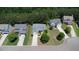 An aerial view of a neighborhood showcasing well-maintained homes, lush greenery, and tree-lined streets at 1575 Parkside Village Dr, Cumming, GA 30040