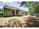 Spacious backyard with a patio, seating, swing set and lush trees around the perimeter at 1575 Parkside Village Dr, Cumming, GA 30040
