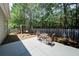 Relaxing patio area with outdoor seating and a swing set surrounded by lush greenery at 1575 Parkside Village Dr, Cumming, GA 30040