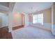 Formal dining room with wainscoting, chandelier, and large window for natural light at 1575 Parkside Village Dr, Cumming, GA 30040