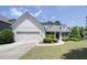 Charming single-Gathering home featuring a manicured lawn and attached two-car garage at 1575 Parkside Village Dr, Cumming, GA 30040