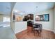 Eat-in kitchen with dark wood cabinets, granite countertops, and stainless steel appliances at 1575 Parkside Village Dr, Cumming, GA 30040