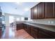 Modern kitchen features dark wood cabinets, granite countertops, tile backsplash and stainless steel appliances at 1575 Parkside Village Dr, Cumming, GA 30040