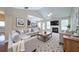 Spacious living room featuring vaulted ceilings, a cozy fireplace, and comfortable, stylish furniture at 1575 Parkside Village Dr, Cumming, GA 30040