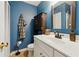 Bathroom featuring a modern sink and vanity, complemented by the tile flooring and a well-lit space at 2031 Dennis Pl, Buford, GA 30519