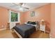 Cozy bedroom with hardwood floors, a well-lit window, and a comfortable bed at 2031 Dennis Pl, Buford, GA 30519