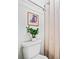 Bathroom features a toilet, framed print art and a patterned shower curtain at 717 Beaufort Cir, Duluth, GA 30096