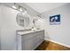 Bathroom featuring a double sink vanity with gray cabinets, a granite countertop, and round mirrors above at 717 Beaufort Cir, Duluth, GA 30096