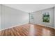 Clean, light-filled bedroom with hardwood floors and natural light from two windows at 717 Beaufort Cir, Duluth, GA 30096