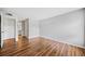 Spacious bedroom featuring hardwood floors, white trim, and convenient access to an en-suite bathroom at 717 Beaufort Cir, Duluth, GA 30096