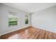 Bright bedroom featuring hardwood floors and two windows providing ample natural light at 717 Beaufort Cir, Duluth, GA 30096