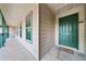Condo front door view with door mat, windows, and a long covered entrance at 717 Beaufort Cir, Duluth, GA 30096