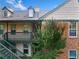 Close up of a two-story condo exterior showing a green tree and staircase to a unit at 717 Beaufort Cir, Duluth, GA 30096