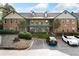Two-story condo complex showing parking lot and exterior elevation with stairs to the units at 717 Beaufort Cir, Duluth, GA 30096