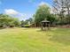 A green community lawn featuring a shaded gazebo structure, perfect for outdoor relaxation at 717 Beaufort Cir, Duluth, GA 30096