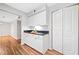 Bright kitchen area with white cabinets, dark countertops, hardwood style flooring and pantry closet at 717 Beaufort Cir, Duluth, GA 30096