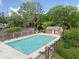 A sparkling swimming pool with lounge chairs, a fence and ample greenery for community enjoyment at 717 Beaufort Cir, Duluth, GA 30096